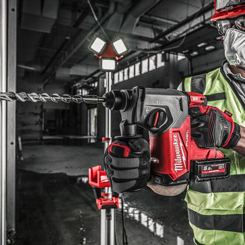 Worker using MILWAUKEE® M18 LED Torch on jobsite, featuring adjustable brightness and weather-resistant design Worker using MILWAUKEE® M18 LED Torch on jobsite, featuring adjustable brightness and weather-resistant design